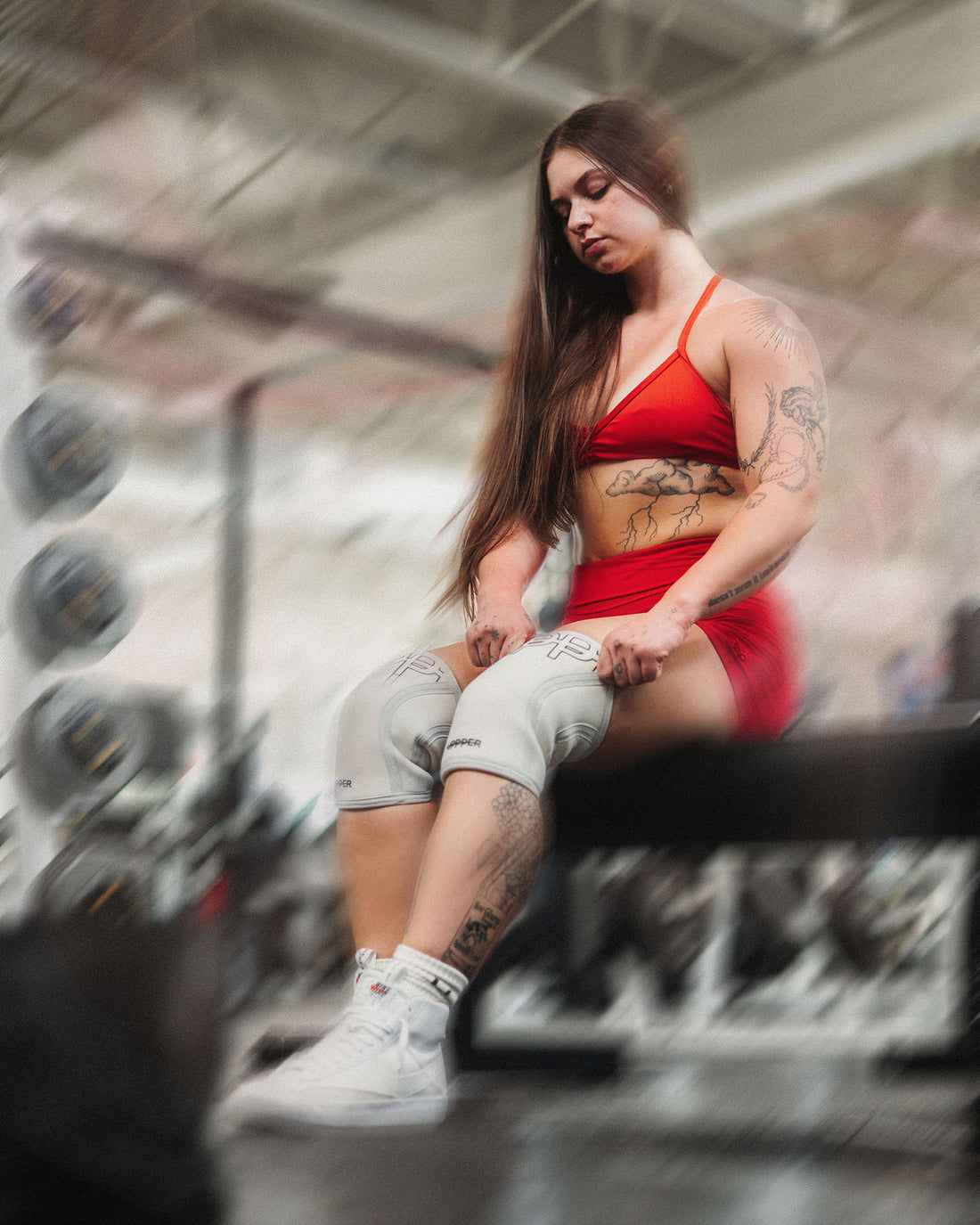 woman putting on uppper knee sleeves