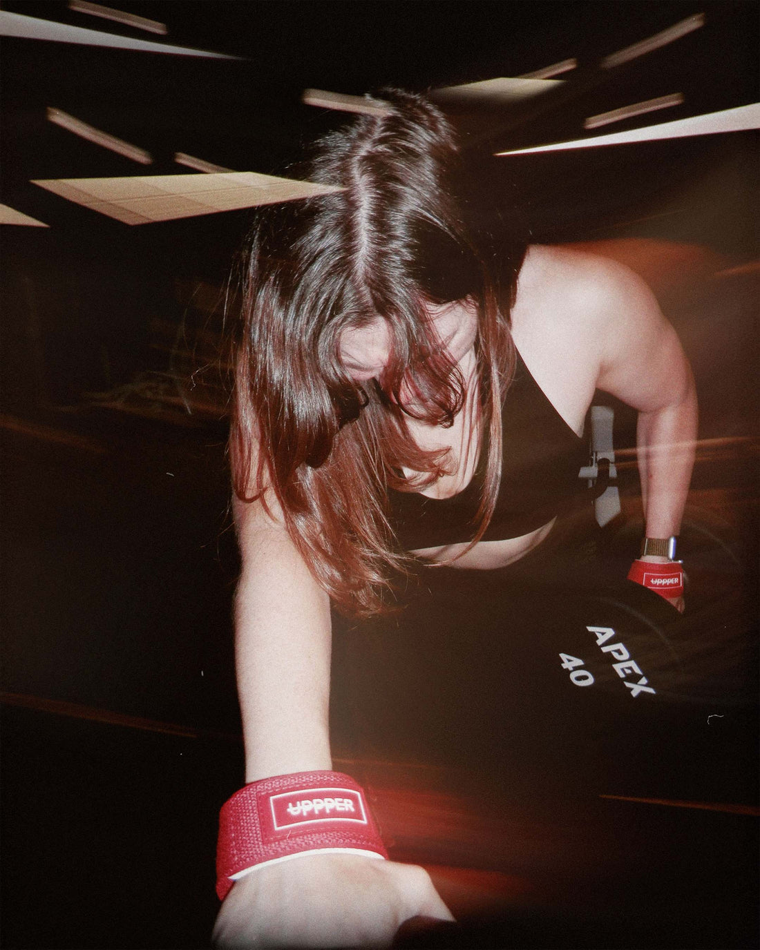 woman strength training with uppper lifting straps